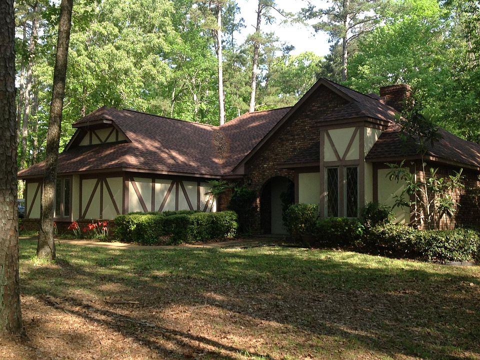 View of front of house, situated well back from the street on 3 acre lot with a lot of privacy, very quiet neighborhood. Due to trees, very small mowing area. A push mower is adequate for regular mowing around the perimeter of the house.
