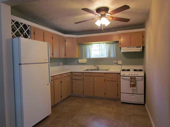 Restored wood stove adds a cozy touch to the charming living room.