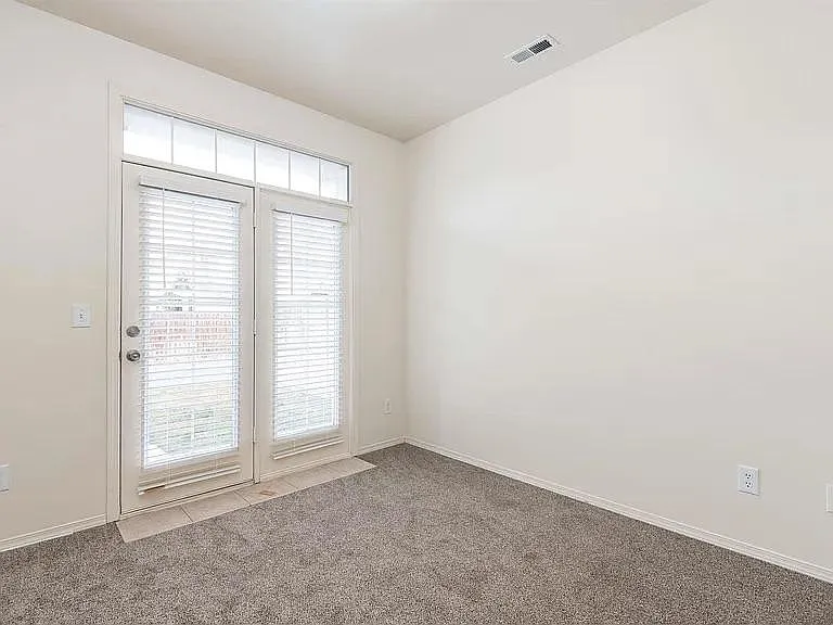 Back bedroom with French doors. Has closet. Could be nice office.