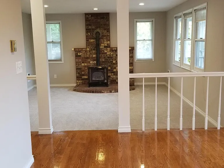 Sunken living room with propane freestanding stove.