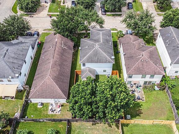 Rear drone view of home, notice the mature trees