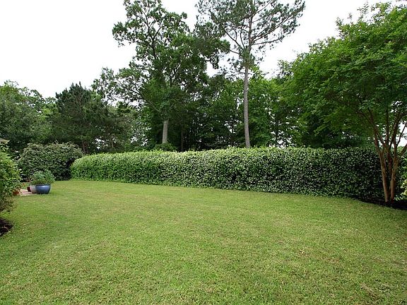 The back fence is covered in lovely and fragrant Jasmine that provides a nice backdrop to the yard.