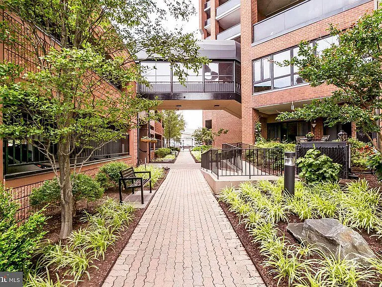 Secure garden and covered walkway between building and garage (from promenade end)