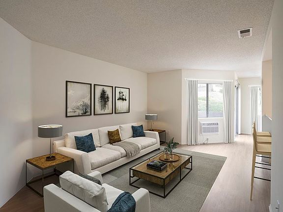 Renovated Package I living room with hard surface flooring