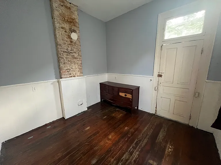 Back bedroom with back entrance to backyard, deck, and laundry room
