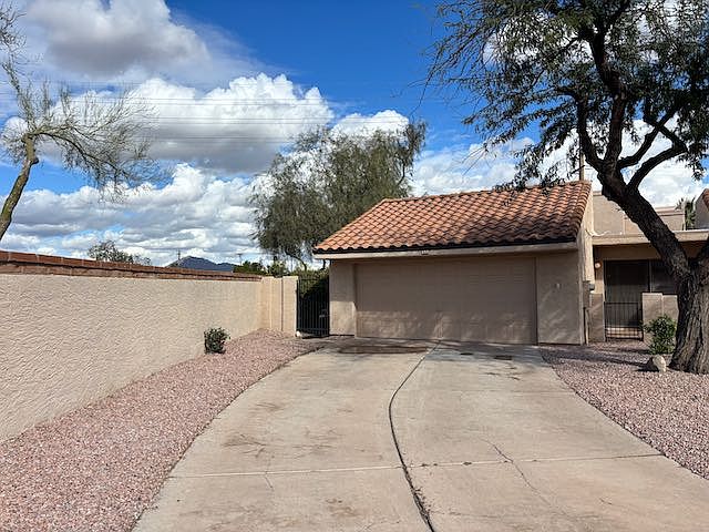 Front with long driveway and 2 car garage