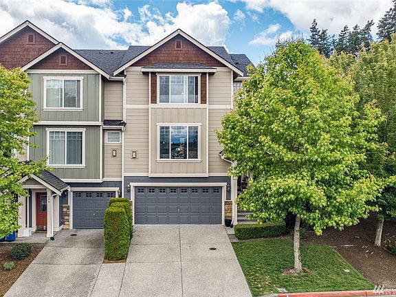 Spacious driveway, side by side two car garage.