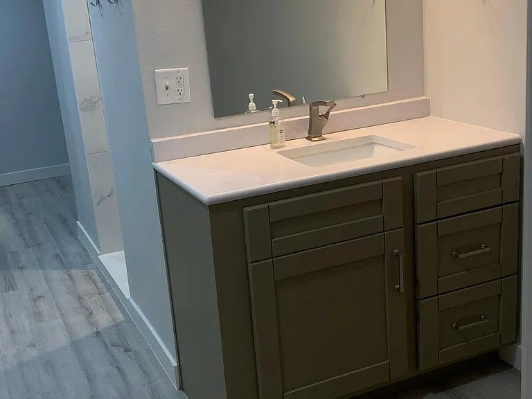 Lower level bathroom vanity with LVP flooring.