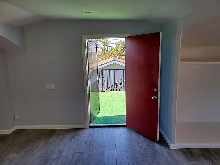 4th upstairs bedroom w/ open door to extra deck patio