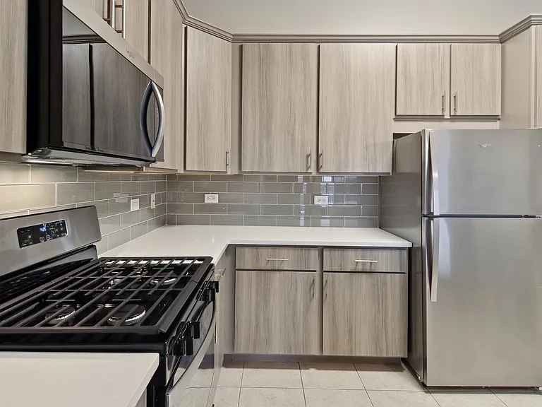 Full kitchen with stainless appliances and tile floors
