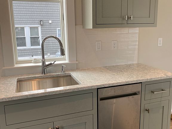 Kitchenette with quartzite countertops, tile backsplash