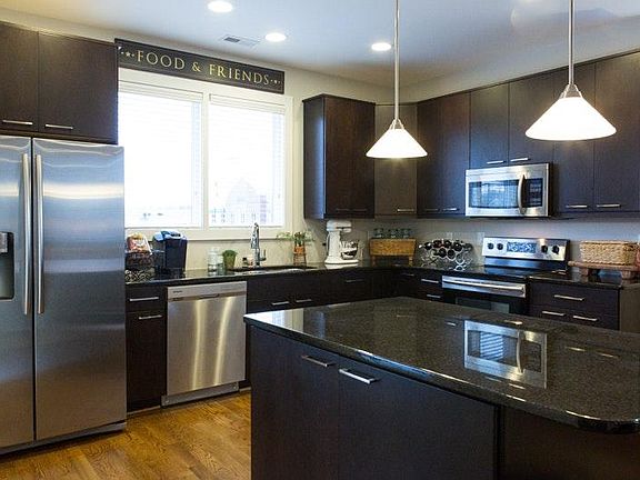 The kitchen is complete with granite and stainless appliance
