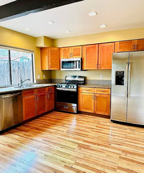 Kitchen with granite countertops, and stainless steel appliances. Refrigerator included with rental