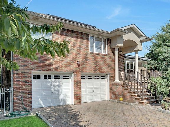 Two car garage with pavers driveway