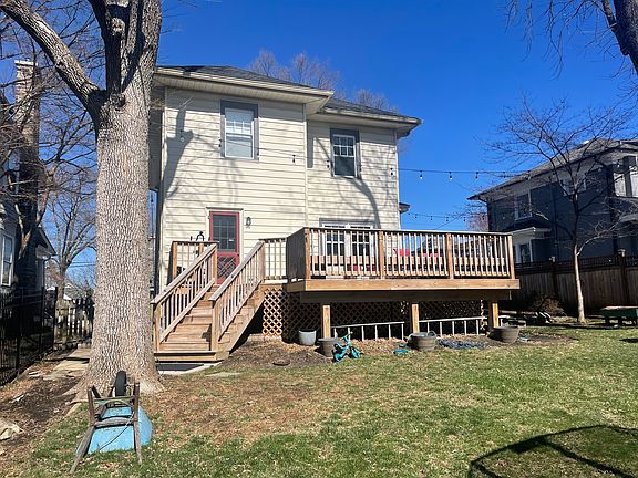 Backyard facing back of house with large deck