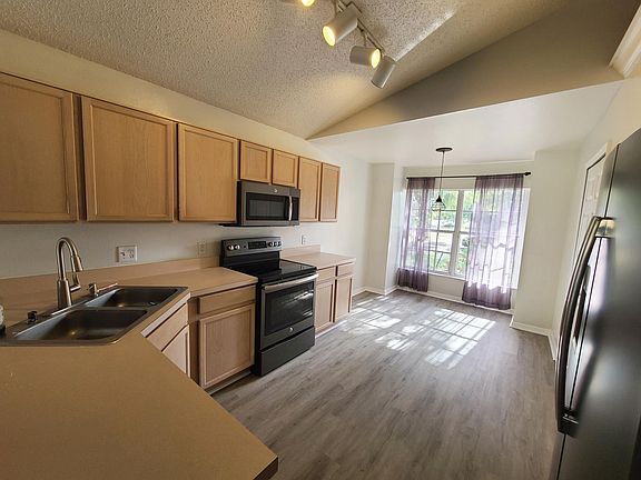 Kitchen with breakfast nook, new faucet and updated GE appliances.