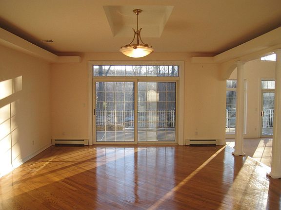 Formal Dining Room walks out to stone patio with illuminated tray ceiling...