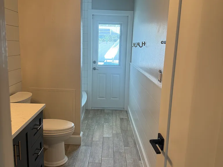 hall bathroom, door to outside pool area