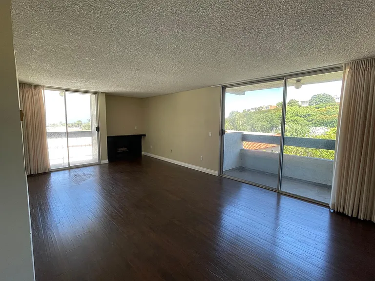 Living room with large windows, ocean view on one side and plenty of light