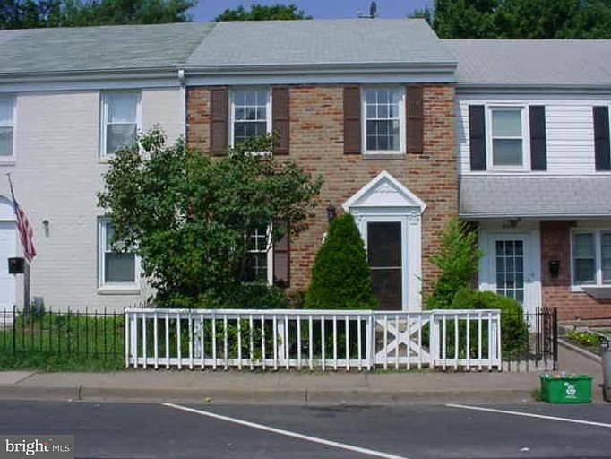 fake plastic lawn in front and rear of home, trees have been removed