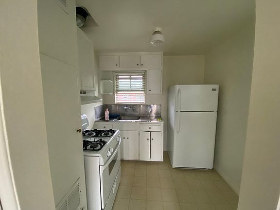 Nice sized kitchen with fridge and stove included. Space for small dining table to the right.