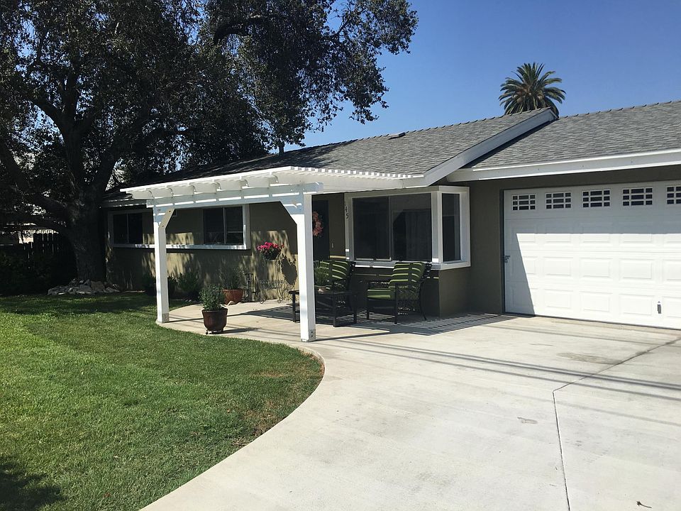 New patio cover, driveway, and garage door. Nice shade in t