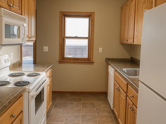 Kitchen full view, kitchen table on the opposite side of the room.