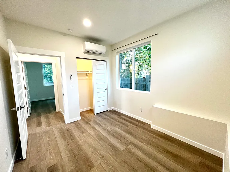 Front bedroom from corner and view into back bedroom.