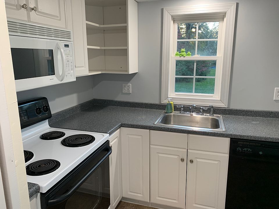Kitchen with washer-dryer, stove, oven, microwave, and refrigerator.