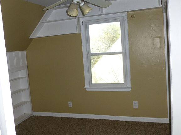 Upstairs bedroom with built-in shelving