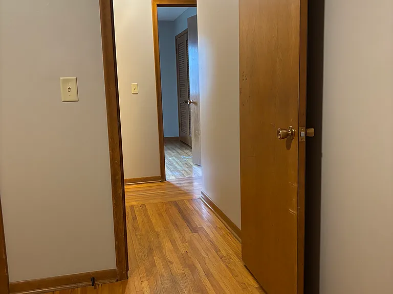 Bedroom 2 going into hallway. The bathroom is to the left and bedroom 1 is straight ahead.
