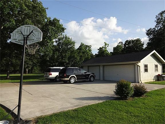 Huge parking area next to three car garage