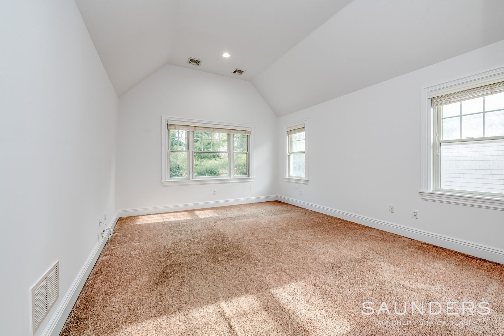  Primary on second floor with wall to wall rug and vaulted ceilings 