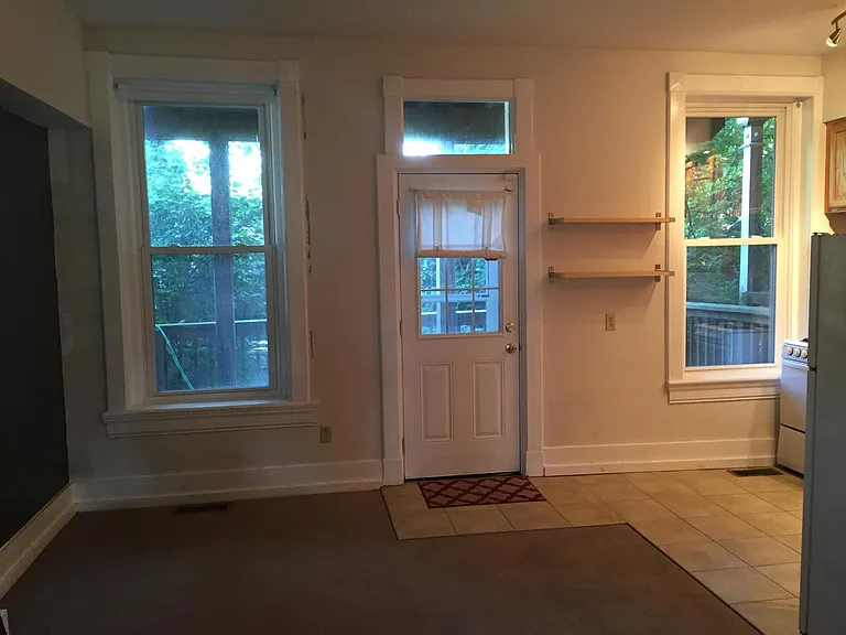Rear of apartment with door to private deck.