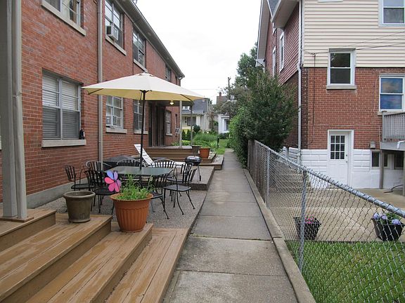 Outdoor patio area with tables and grill.