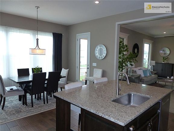 Rich look and feel in this open kitchen and dining area. Dark hardwoods add to the elegance.