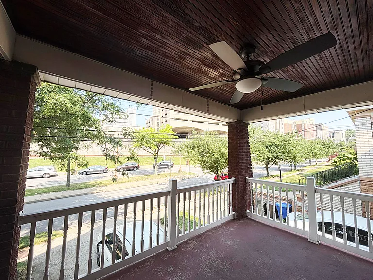 A lovely porch view with beautiful wood ceiling.