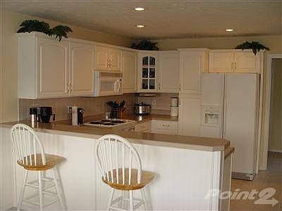 Nice open kitchen with lots of natural sunlight. The kitchen offers plenty of cabinet and countertop