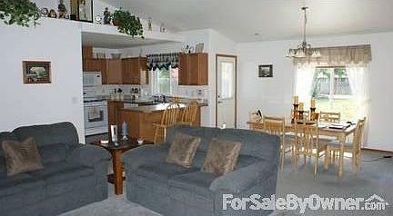 Living/Dining/Kitchen : Vaulted ceilings, large pantry, front bay window, back patio door.