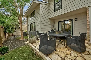 2nd outdoor seating area and space for grill and pets or kids to roam in fences in private backyard.