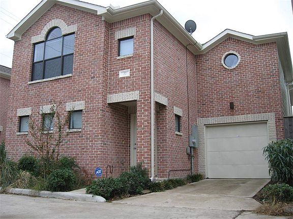 This is the exterior view of this 2-story brick home. It also has a 1-car garage.