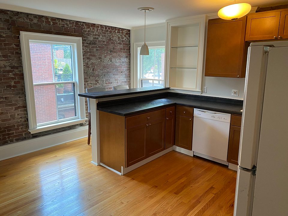 Sitting bar in kitchen with authentic natural exposed brick wall.