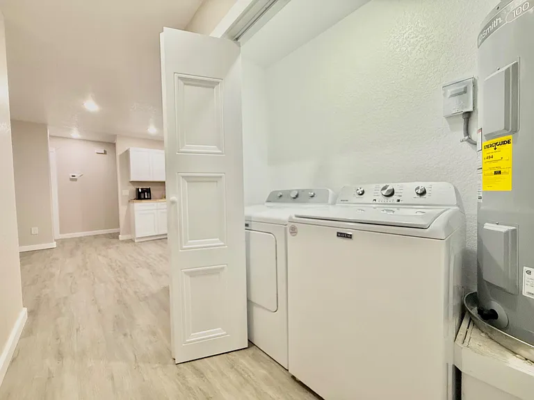 Convenient in-home laundry nook with full-size washer and dryer, located off the main living area for easy access.