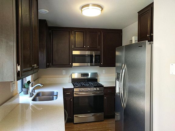 Kitchen with quartz counter tops and new appliances, includes refrigerator