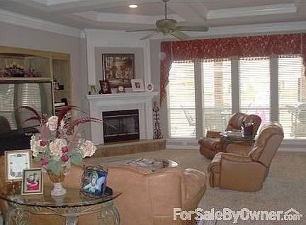 Living Room : Large living room with gas fireplace and a wall of built-ins. Crown molding.