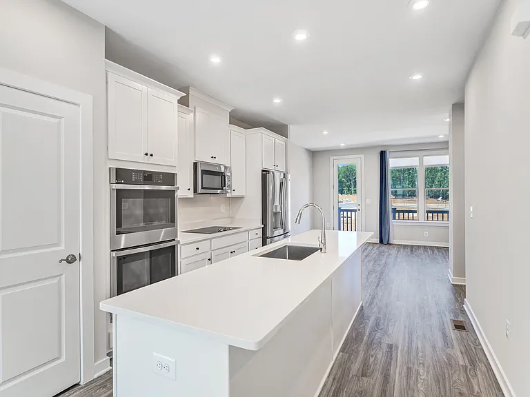 Modern open kitchen with quartz countertops, stainless steel appliances, and plenty of space for cooking and entertaining.