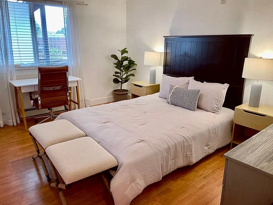 Bedroom 1 with a comfy Queen bed + desk/workspace