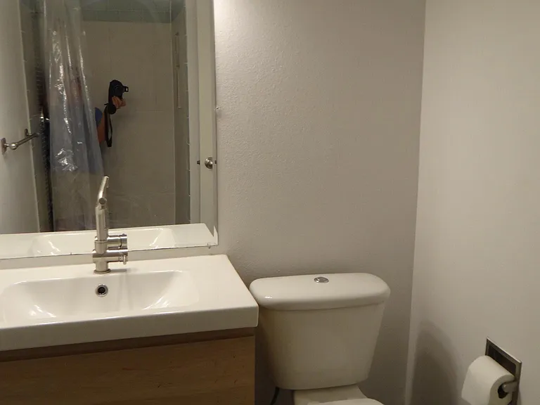2nd Bathroom with modern cabinet and toilet and tiled shower