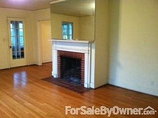 Living Room : Hardwood floors and brick fireplace.