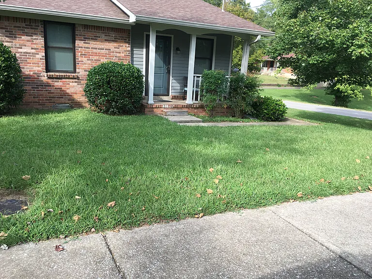 Front porch with driveway parking off the side street